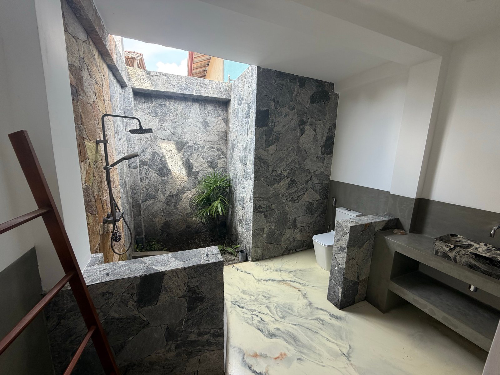 Medium downstairs bedroom — private outdoor en-suite with shower, toilet and basin.