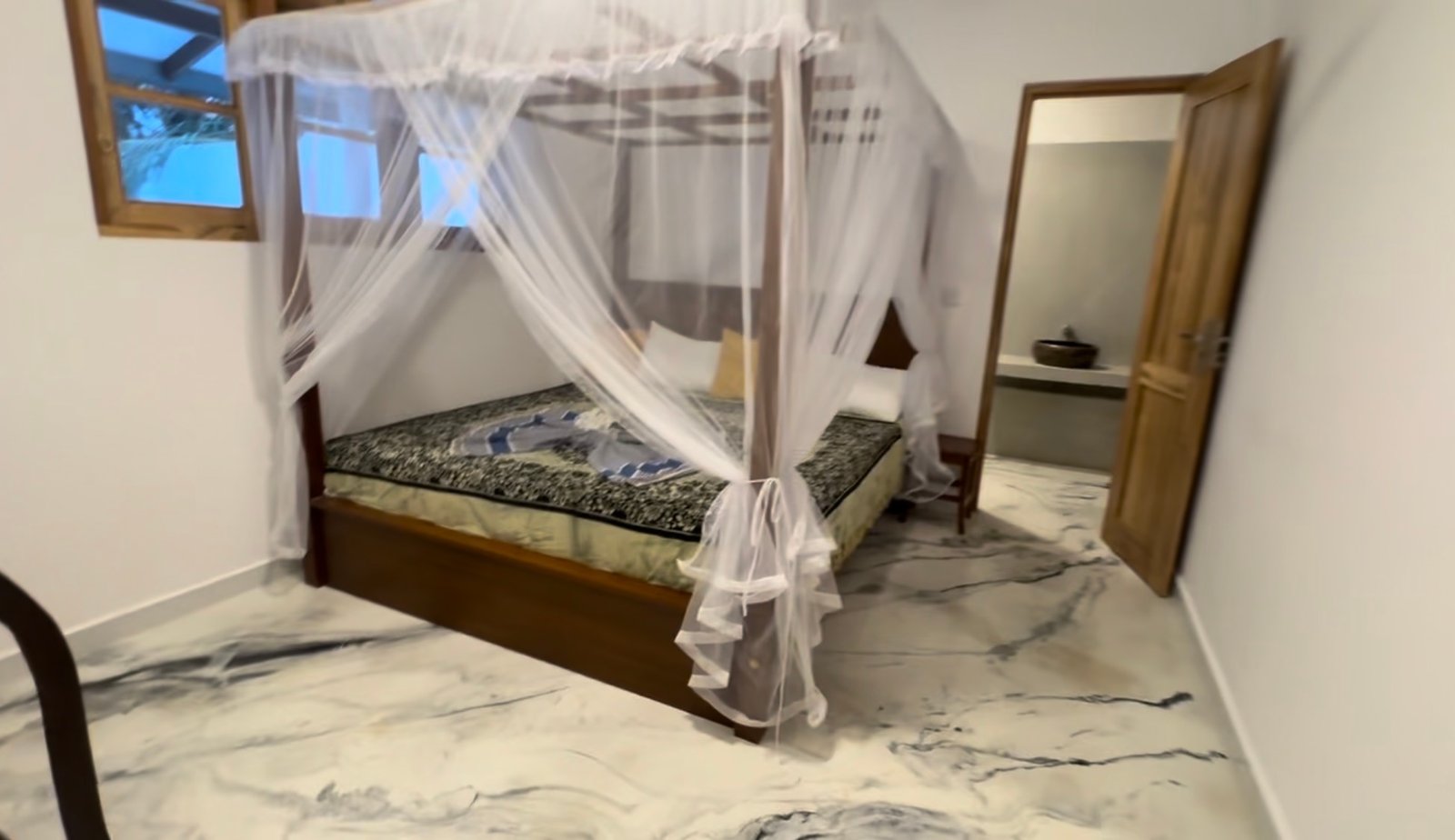 Medium downstairs bedroom — super-king bed, ceiling fan and no air conditioning. Private indoor en-suite shower room with shower, toilet and basin.