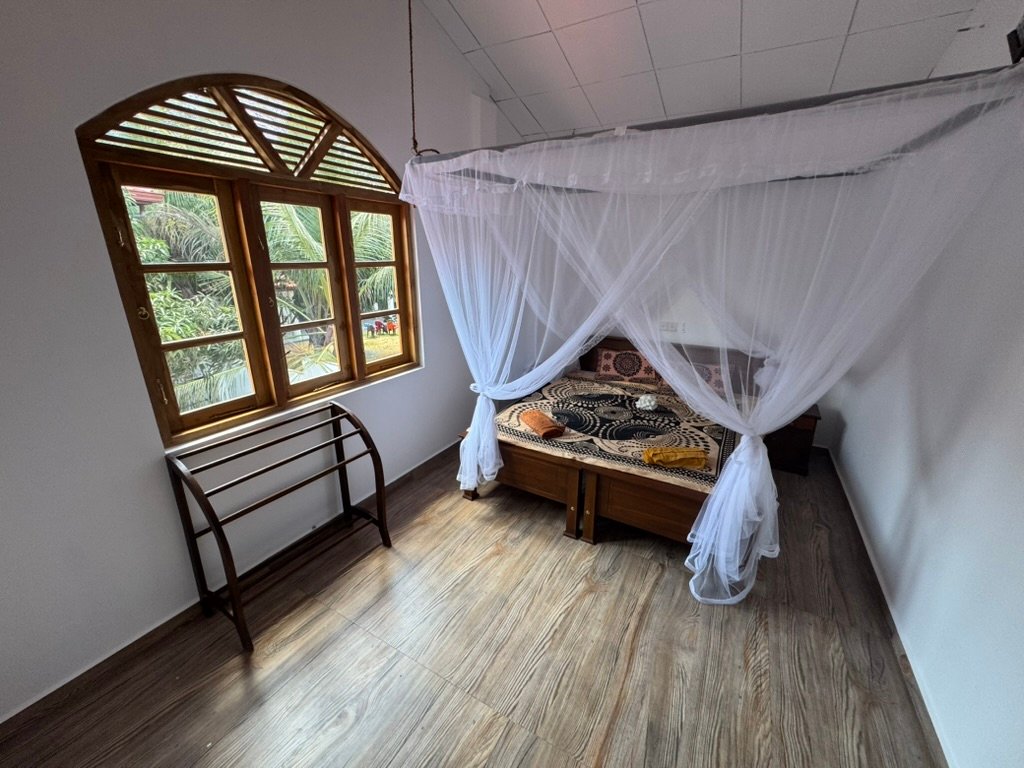 Second upstairs bedroom — air conditioning and a super-king bed convertible to twins on request. Shared upstairs bathroom with shower, toilet and double basin.